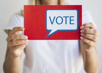 Front view woman holding a voting message