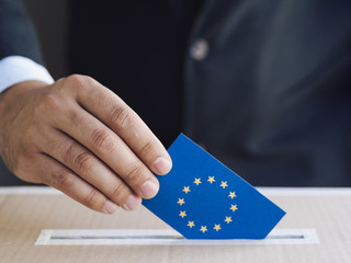Man putting an european election ballot in a box