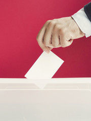 Man putting an empty ballot in a box