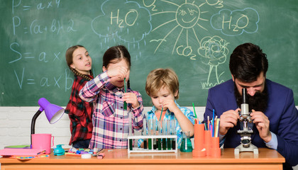 Man bearded teacher and pupils with test tubes in classroom. Observe reaction. Science is always the solution. School chemistry experiment. Explaining chemistry to kids. Fascinating chemistry lesson