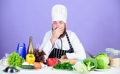 Colorful culinary. Professional chef in cook uniform. tired bearded man cooking in kitchen. Dieting with organic food. Fresh vegetables. Healthy food and vegetarian. Vitamin. man use kitchenware