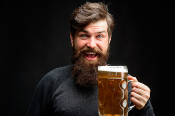 Enjoy in pub. Happy brewer. Celebration oktoberfest festival concept. Man in beer pub. Bearded man holds mug of craft beer. Brewery concept. Happy smiling man with beer. Alcohol, harmful habits.