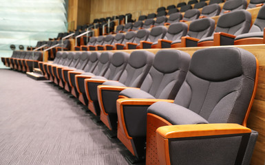 Closeup  of new indoor modern designed seats row in the theater. 