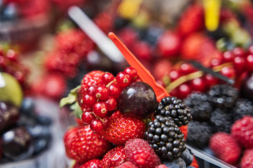 Blackberry, raspberry, blueberry, mix of berries in a plastic cup