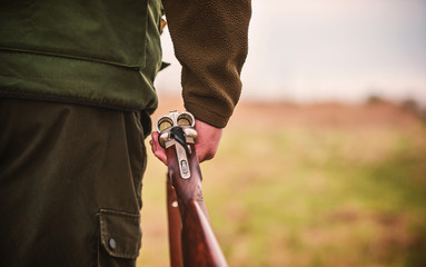 Hunter with a rifle in hunting