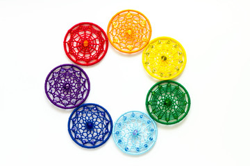 Handmade dream catcher with feathers threads and beads rope hanging on white background