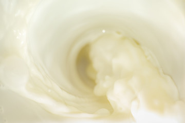 Background with flowing white milk, soft focus