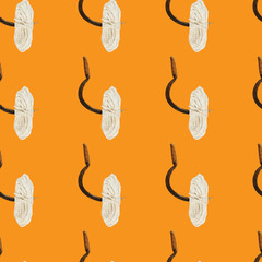 Seamless background with rope and sickle on a orange background