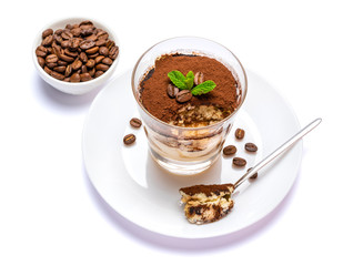 Classic tiramisu dessert in a glass cup on the plate on white background with clipping path