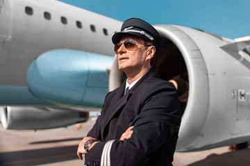 Handsome pilot in uniform posing for camera