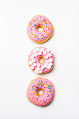 Fresh sweet pink bonuts on white studio background