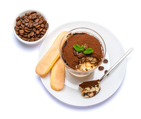 Classic tiramisu dessert in a glass cup on the plate on white background with clipping path