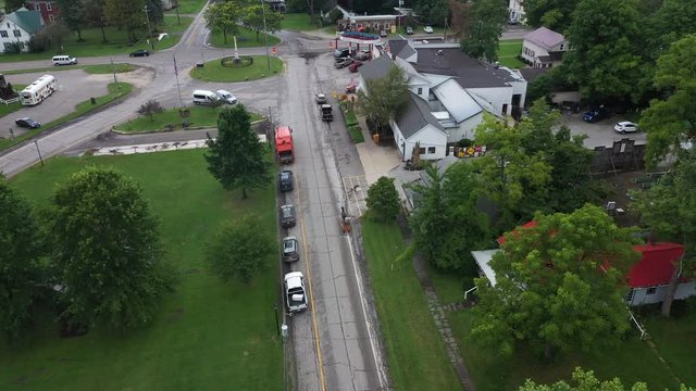 Aerial Middlefield Ohio Amish community horse buggie carriage on street. Settled late 1700's as pioneer religious settlement. Old Amish Mennonite town. Rural old order.