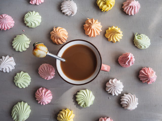 Coffee with sweet colorful fruit marshmallows, shot from the top angle