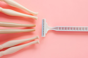 Disposable shaving machine for women on a pink pastel background, flatley, copy space.