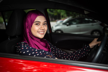 Happy Muslim Female in her car.