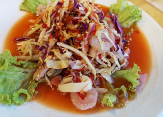 Thai spicy fresh shrimp salad on white plate, Very famous food in Thailand, Thai food with herbs and spices ingredients - Image