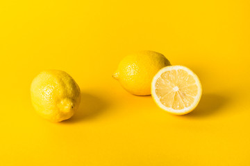 Natural fresh juicy lemons on yellow background