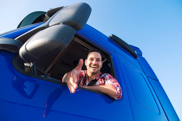 Truck drivers job openings. Truck driving careers. Middle aged professional trucker driver sitting...