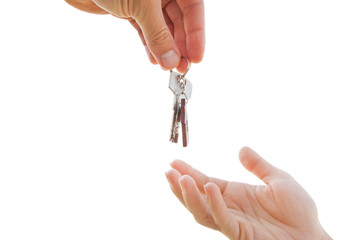 Man giving the metal key from door with wooden trinket in shape of house to the woman