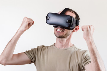 Man exploring modern technology virtual reality with head mounted display on white background