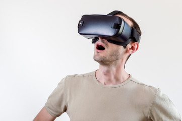 Man exploring modern technology virtual reality with head mounted display on white background