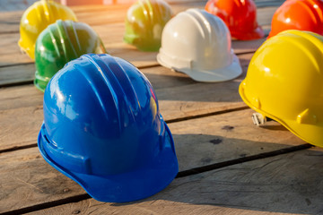 Safety helmet (hard hat) for safety and health officer,engineer or architect place on old wooden...