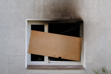 Barricaded window after the fire damage in an apartment house, concept for arson, negligence and...