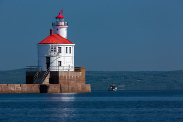 Fototapeta na wymiar Wisconsin Point Lighthouse On Lake Superior with Fishing Boat