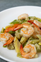 Fried vegetables with shrimp in oyster sauce for healthy in white dish on concrete table.
