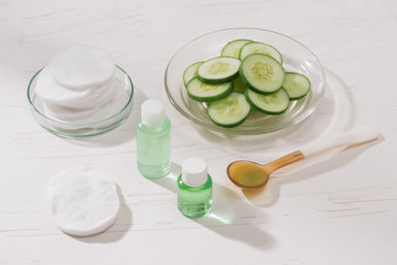 Cosmetic bottle and fresh organic cucumber for skincare. Home spa concept.