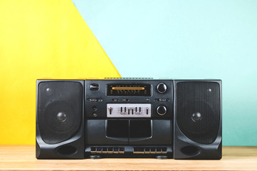Old tape recorder on yellow-green background. Concept of the 80s or 90s