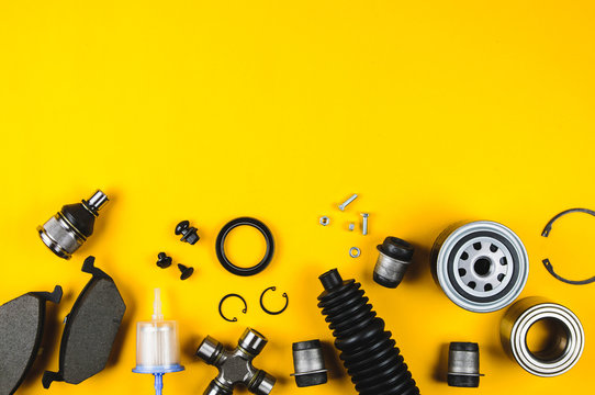 Set of car parts for maintenance on yellow background