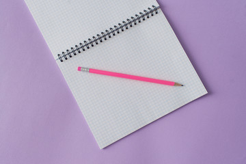 Education concept - pink pencil close up and opened notebook for educational new academic year begin or study.Back to school. Copy space