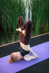 Girl practice yoga early morning on pier