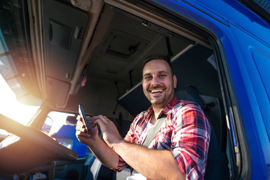 Truck Driver With Tablet Using GPS Navigation For His Route. Transportation Services.