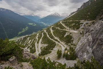 U-shape curved road towards Towers of Fraele, a touristic attraction in North Valtellina, Italy.
