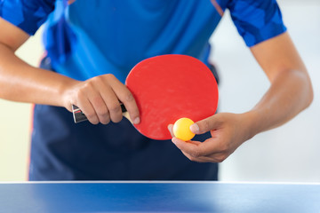 Ping pong table, Male playing table tennis with racket and ball in a sport hall