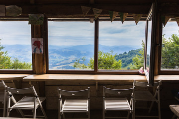 Mountains, view from the window of a wooden house