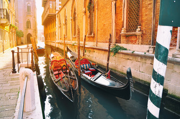 Gondola boats on canals in Venice Italy