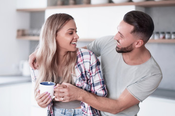 happy young couple in kitchen in good morning time