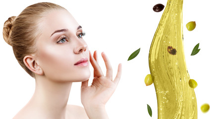 Young beautiful woman near splash of olive oil.