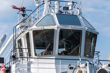Ship bridge for navigation and control. Cargo ship waiting for a captain and crew. Vessel is ready to shove off and start new voyage. © TRAVELARIUM