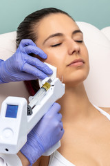 Woman having facial mesotherapy with micro needle technology.