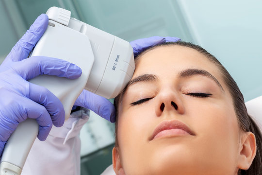 Young Woman Having Non Invasive Ultrasound Plasma Lift Treatment On Face.