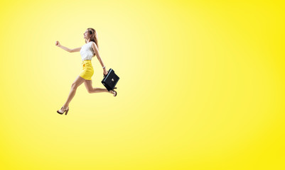 Young cheerful woman running fast with briefcase.