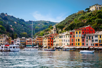 Beautiful small village Portofino with colorfull houses, luxury boats and yachts in little bay harbor. Liguria, Italy. On warm brigth summer day