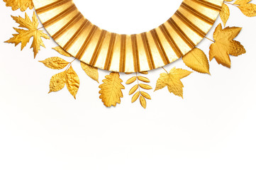 Fashionable vintage modern golden frame and golden autumn leaves isolated on white background. Photo frame, mirror frame, baguette, stylish interior item. Aged wooden gilded frame. Autumn fall concept