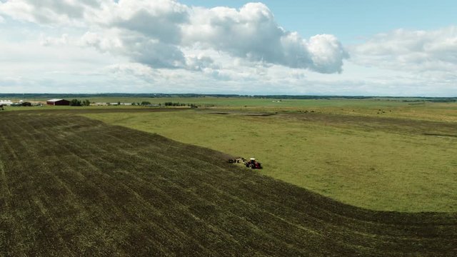 Aerial Drone Shot of Albertan Tractor Discing Field At The End of the Summer Calgary Alberta Canada Agriculture
