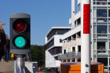 River traffic light for ferry boats with green light on bridge